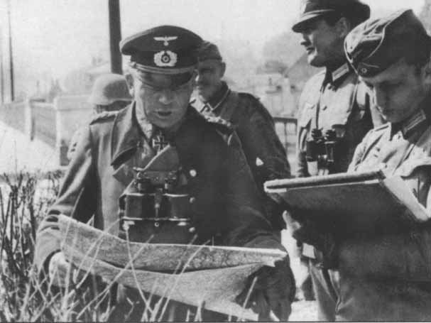 German officers conferring over a map during the advance through the Ardennes.