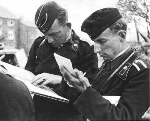 Panzer crewmen writing orders. German practice prized brief written orders over detailed ones.